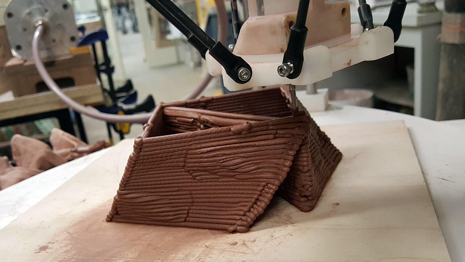 Robotic arm finishing a boxlike print